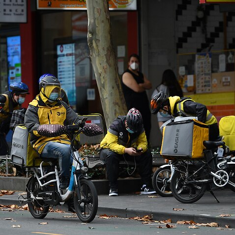 Delivery drivers are seen in Melbourne, Tuesday, June 1, 2021. Victoria has recorded three new additional cases of coronavirus in the past 24 hours. (AAP Image/James Ross) NO ARCHIVING