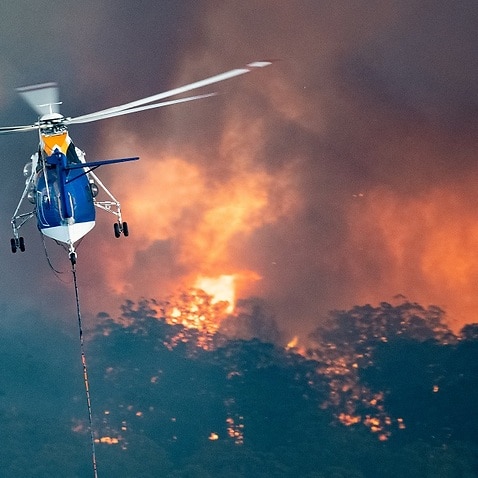 A firefighting helicopter tackles a bushfire near Bairnsdale in Victoria's East Gippsland region.