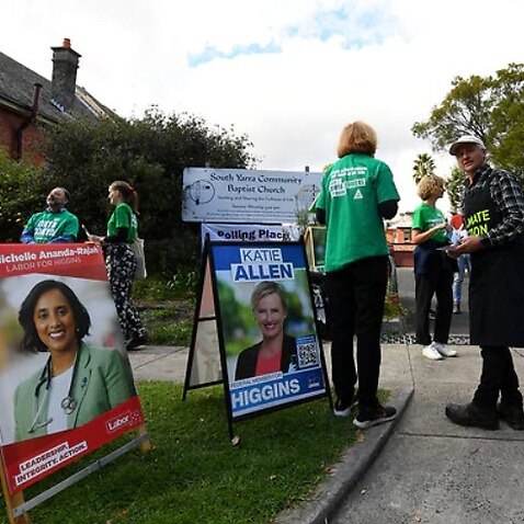 Party Volunteers are seen outside an early voting centre at the South Yarra Community Baptist Church in Melbourne.