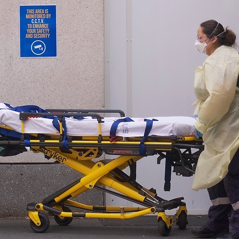 A hospital worker with a stretcher.