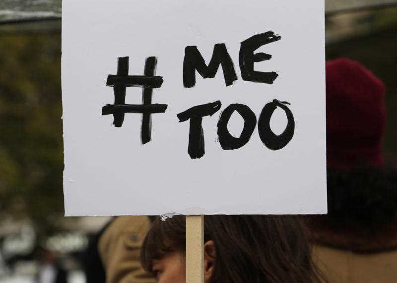 Protesters hold placards during a gathering against gender-based and sexual violence.