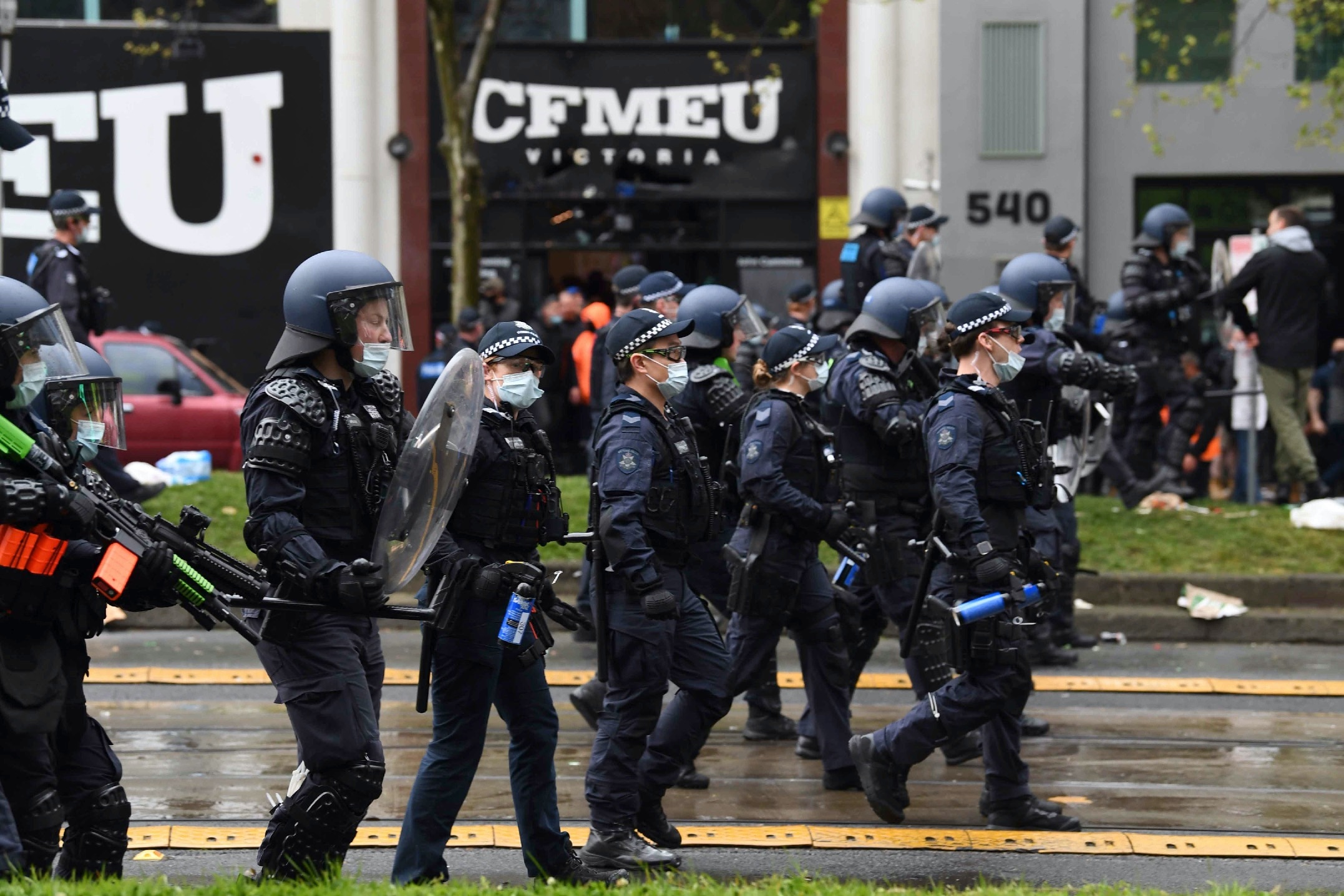 Police in riot gear are seen at a protest at CFMEU headquarters in Melbourne.