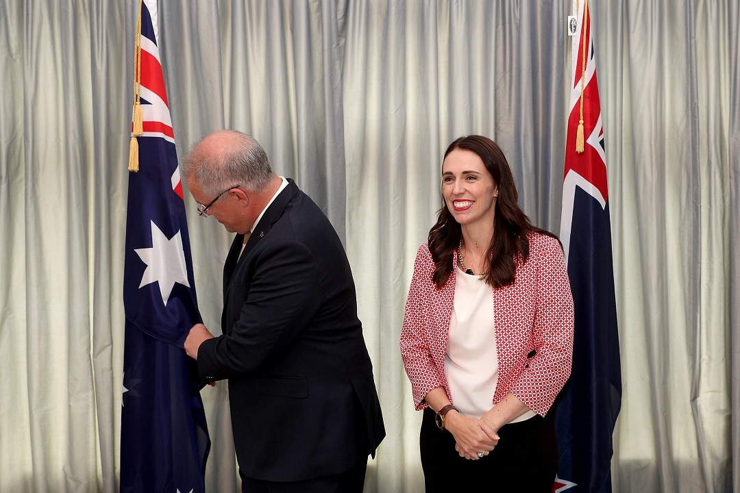 Prime Minister Scott Morrison checks the flag as he meets Jacinda Ardern in Auckland. 