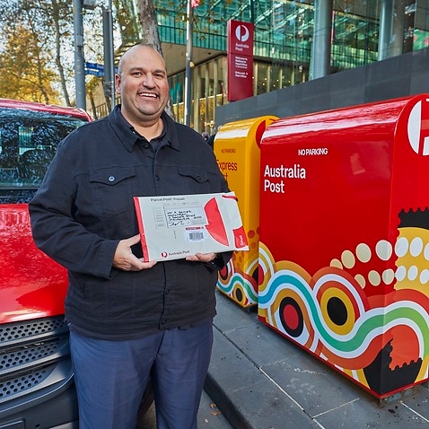 Australia Post Indigenous Manager Chris Heelan with the new packaging.