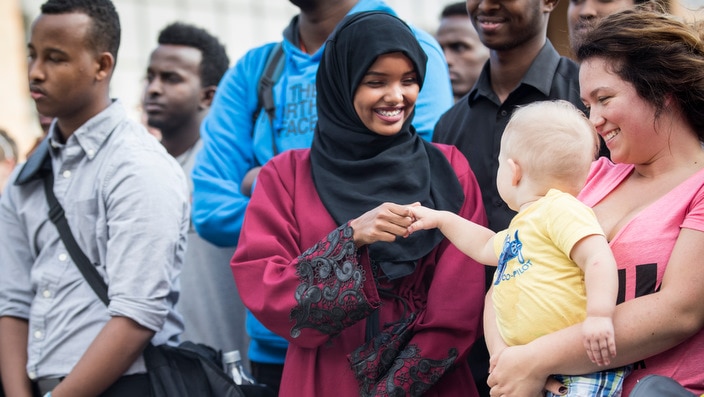 Halima Aden interacts with baby Jayse Waisanen.