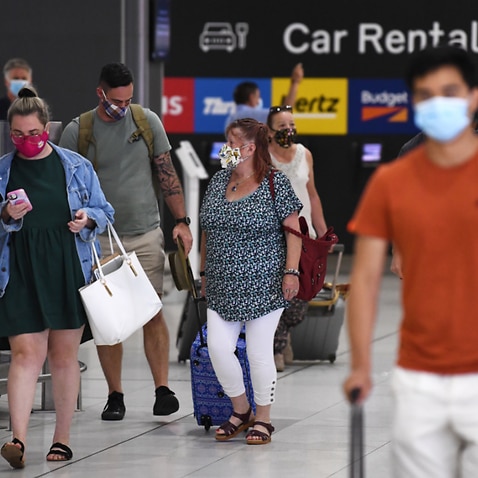 People wearing face masks are seen at Melbourne airport. 