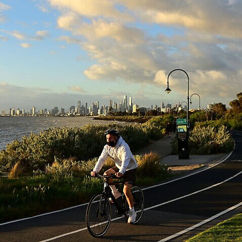 People ride along Elwood Beach on 19 October, 2021 in Melbourne, Australia.