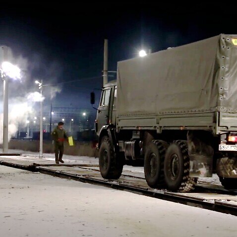 Russian military vehicle drives on a railway platform before transferring to attend a joint military drills in Belarus, in Russia, Monday, Jan. 24, 2022. 