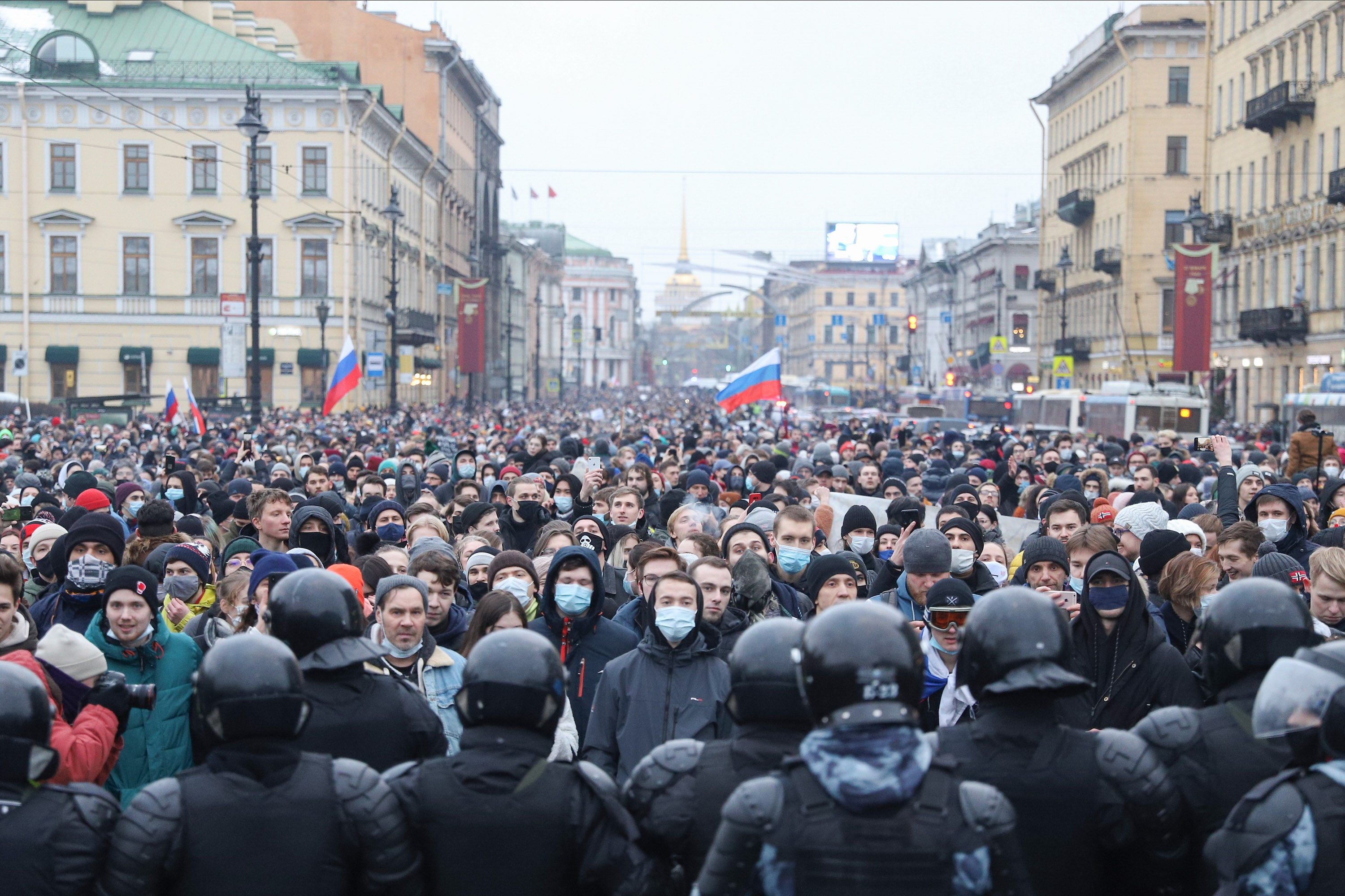 Police officers confront a crowd of protesters during a demonstration in St Petersburg on 23 January.