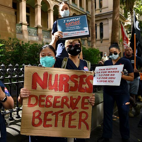 Nurses hold placards during a nurses’ strike outside the NSW Parliament House in Sydney, Tuesday, February 15, 2022