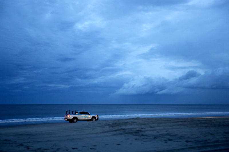 A police vehicle patrols the beach after an evening curfew went into effect as Hurricane Florence approaches Myrtle Beach, S.C., Thursday, Sept. 13, 2018.