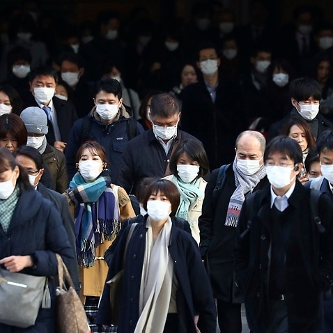 Commuters in Tokyo on Tuesday.