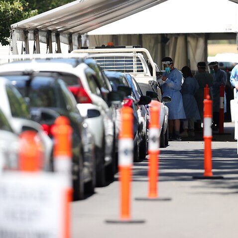 Members of the public are seen queuing in their cars at a drive-through COVID-19 testing site at Albert Park, in Melbourne, Thursday, December 30, 2021. Victorian travellers getting tested to cross state borders are being asked not to show up at testing s
