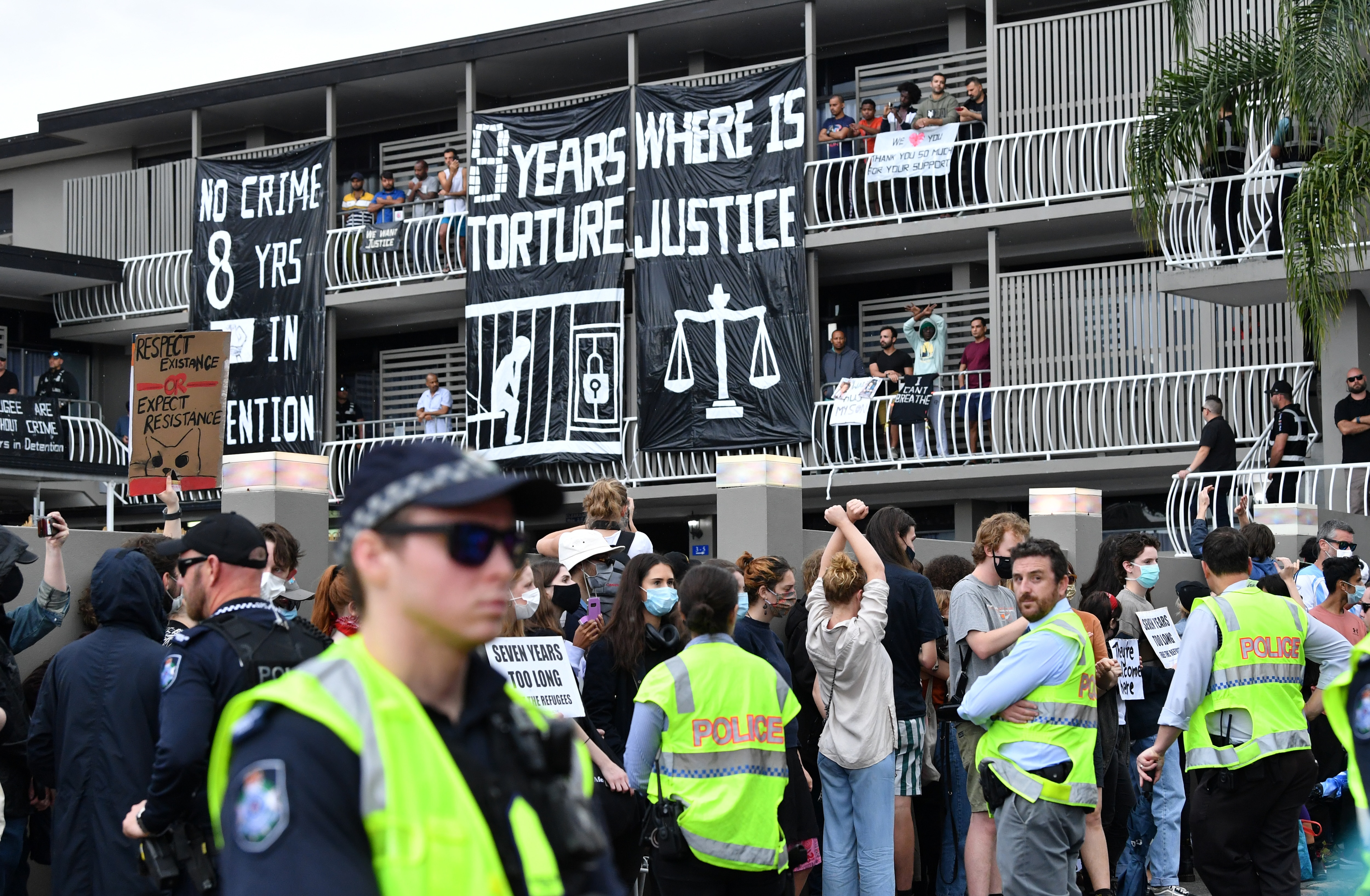Police and protesters are seen during a rally in support of asylum seekers detained at the Kangaroo Point Central Hotel in Brisbane, 15 August, 2020. 