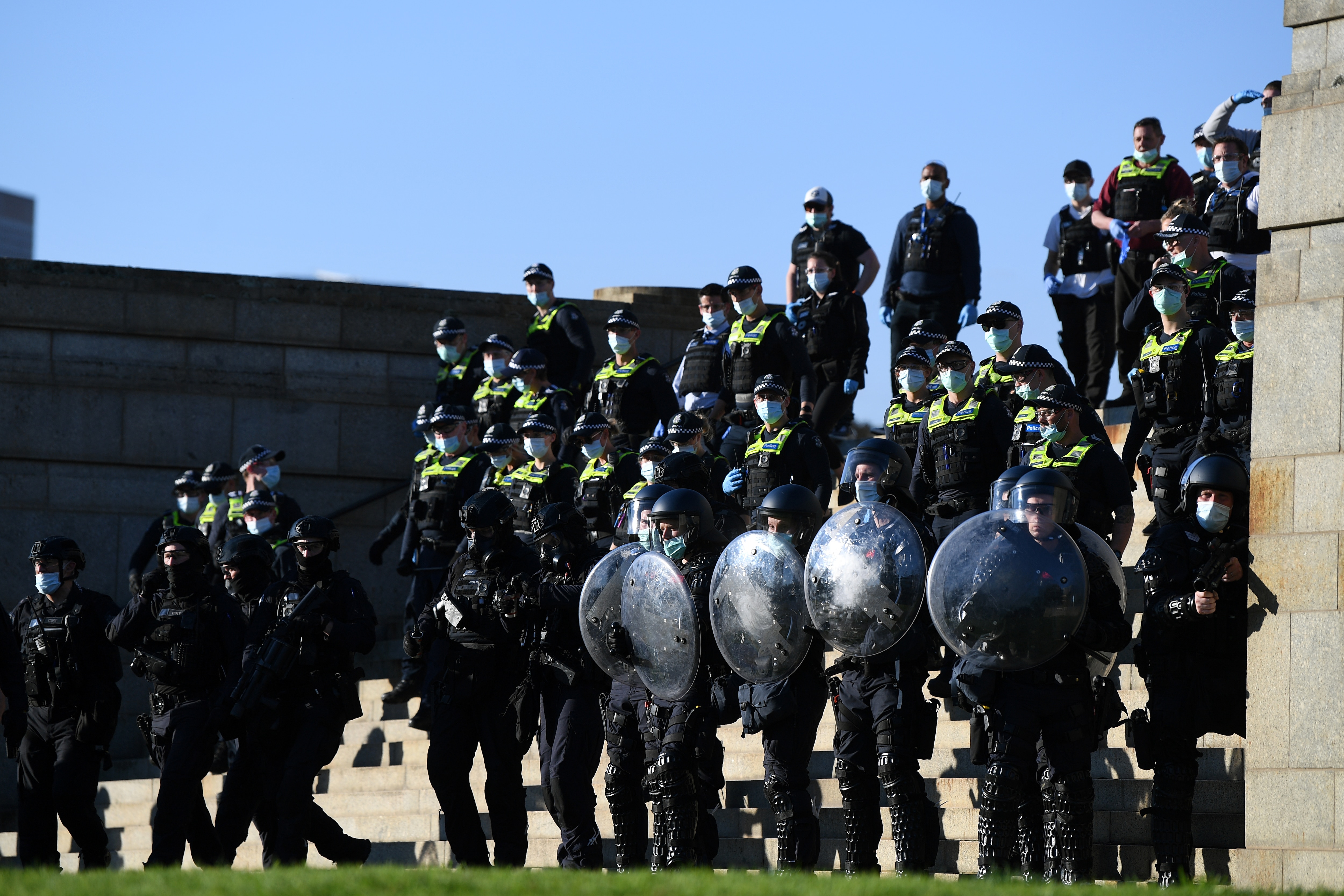 Riot police move protesters on at the Shrine of Remembrance in Melbourne on 22 September, 2021. 