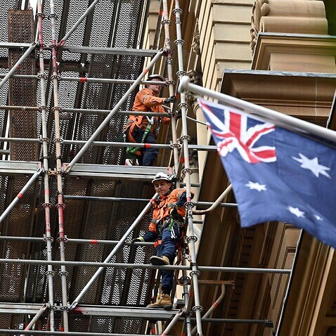 Labourers work at a construction site in the central business district of Sydney on June 18, 2020.