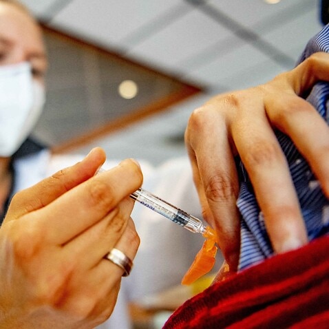 At a general practitioner's practice, people get the flu jab