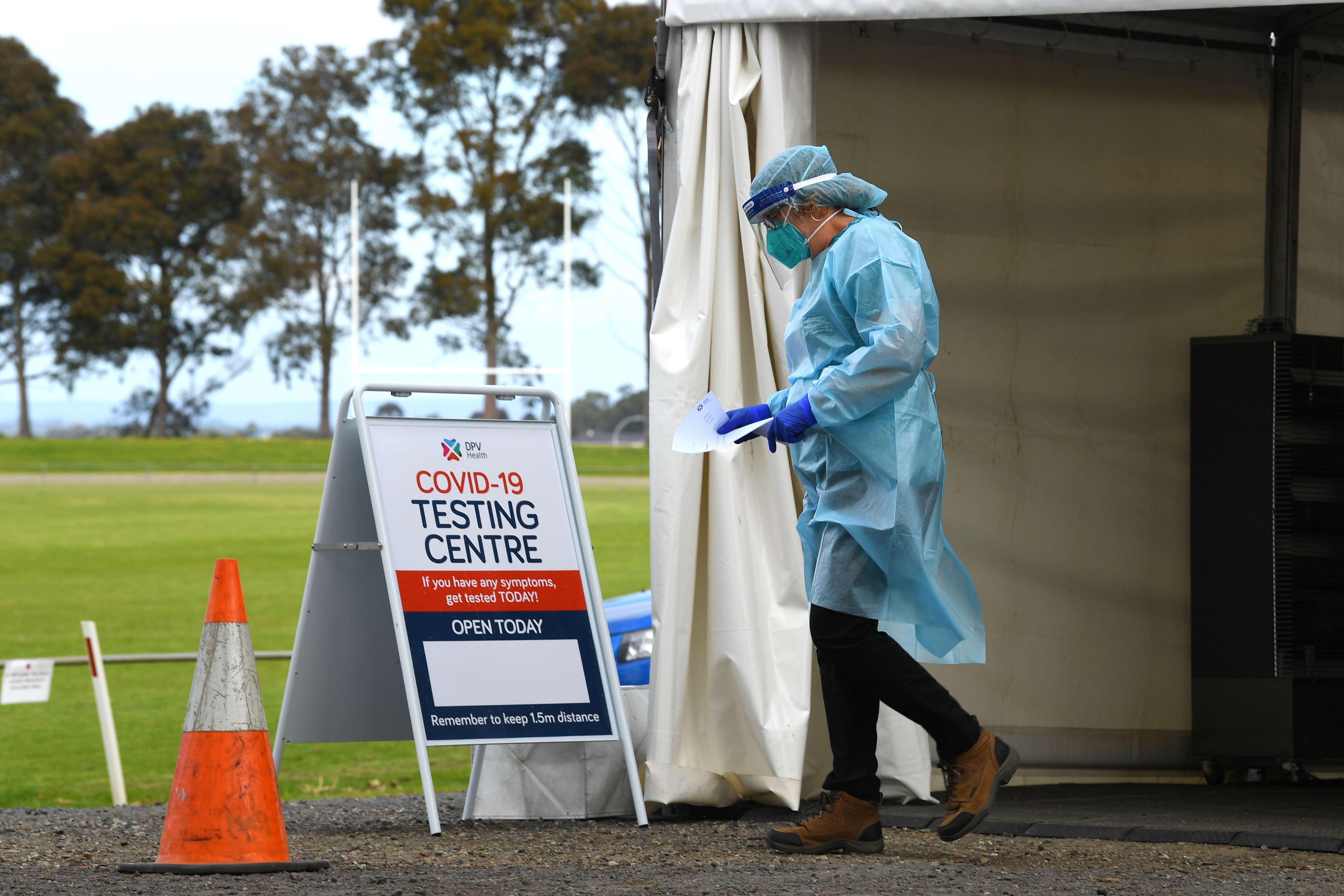 Healthcare workers are seen at a drive through pop up coronavirus testing facility in Clyde, Melbourne.