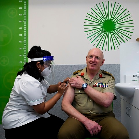 The Coordinator General of Operation COVID Shield Lieutenant General John Frewen receives his COVID-19 vaccination booster dose at Erindale Pharmacy in Canberra, Tuesday, December 14, 2021. (AAP Image/Lukas Coch) NO ARCHIVING