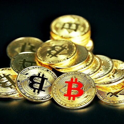 Golden Bitcoin on black background -Executium-Unsplash