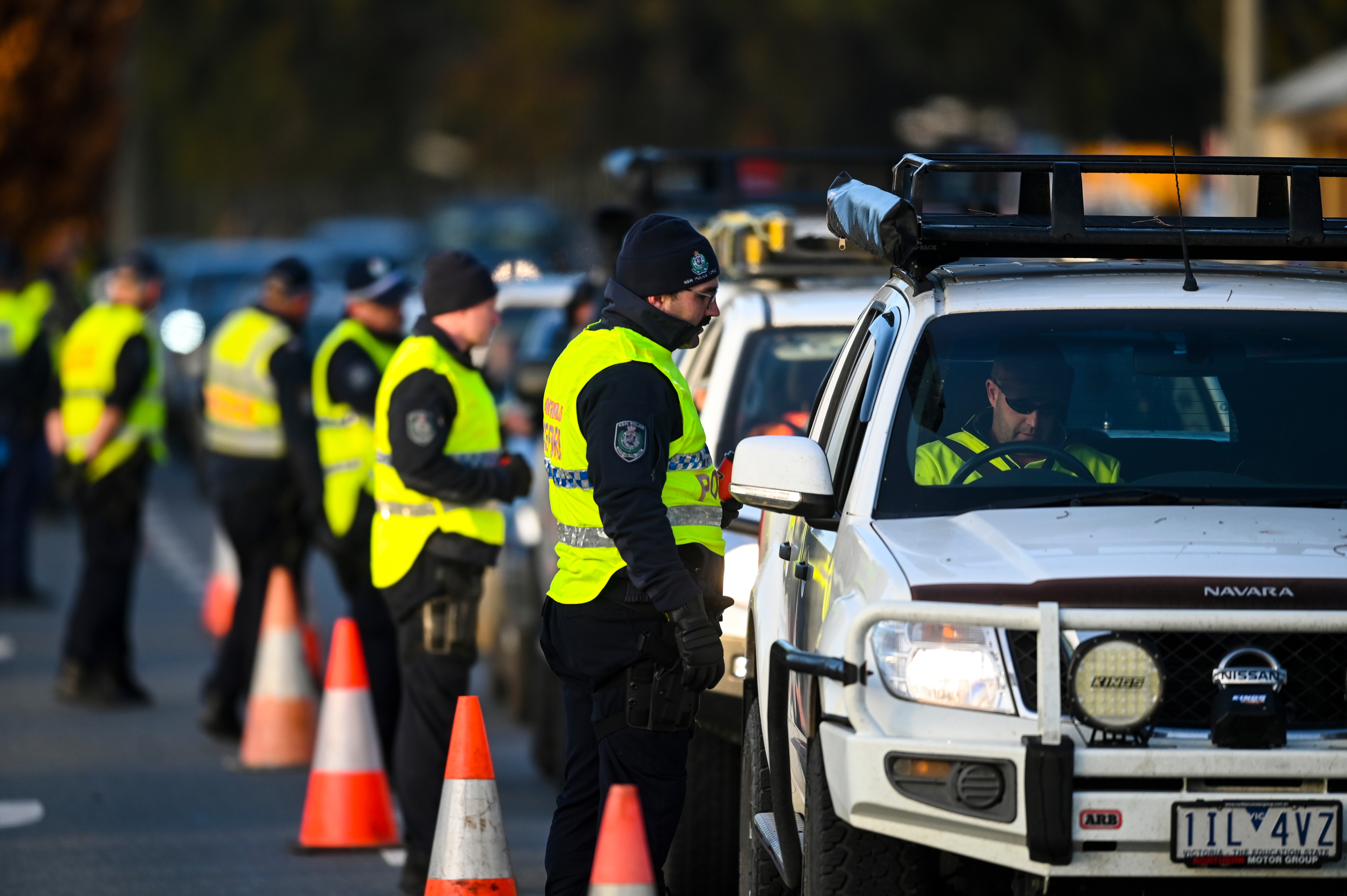 NSW Police officers check cars crossing from Victoria into New South Wales at a border check in Albury, NSW, Wednesday, July 8, 2020