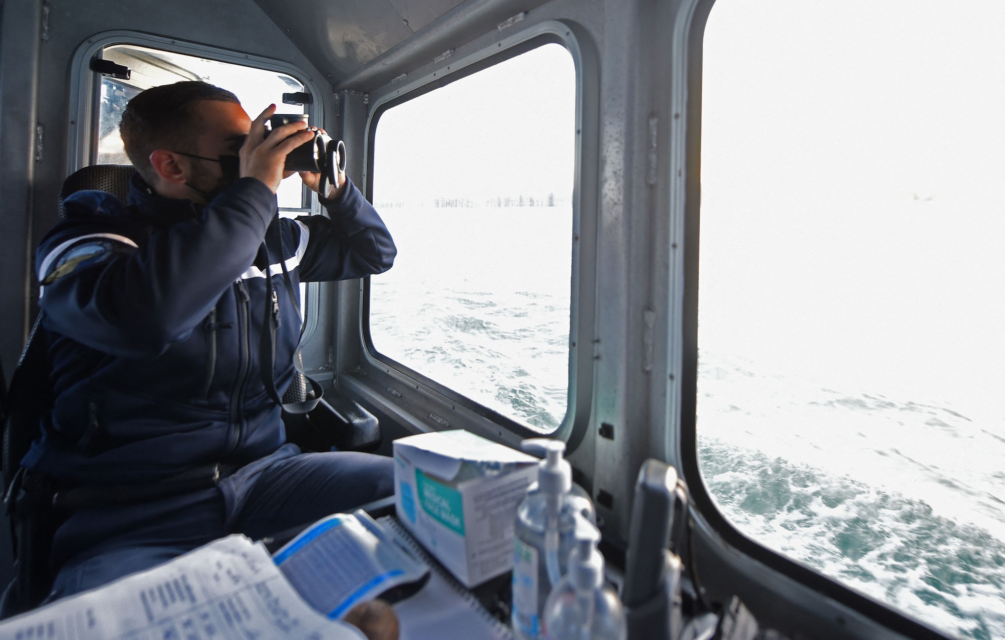 A French Maritime Gendarme from Boulogne-Sur-Mer, south of the port of Calais, searching for migrants trying to cross the Channel.