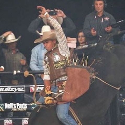 Brazilian rodeo cowboy on bull