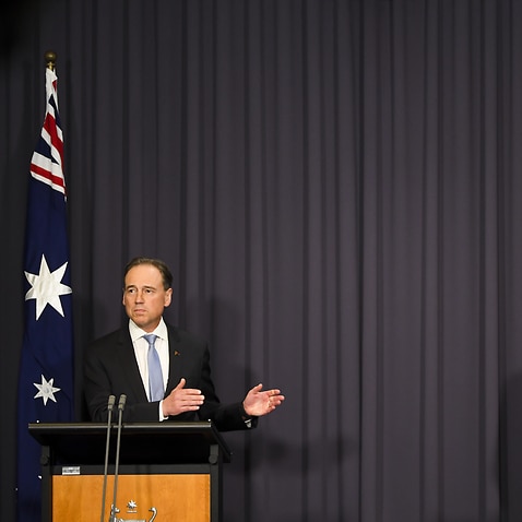 Australian Health Minister Greg Hunt (left) and Australia’s Chief Medical Officer Paul Kelly speak to the media during a press conference at Parliament House in Canberra, Wednesday, October 20, 2021. (AAP Image/Lukas Coch) NO ARCHIVING