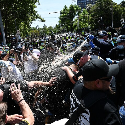Police use OC spray on protesters during an anti-lockdown protest in Melbourne.