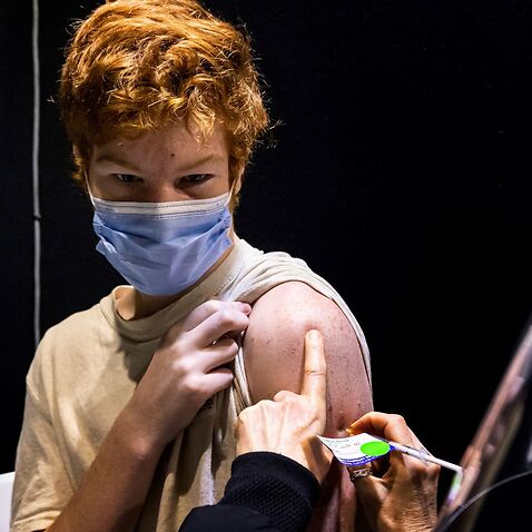 15 year old Jack Guganovic receives a vaccination at the pop-up vaccination clinic at Casey Fields in Melbourne