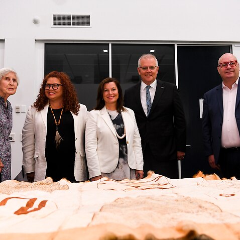 Heather Henderson, Jodie Sizer, Jenny Morrison, Scott Morrison and Craig Ritchie look at Indigenous artefacts.