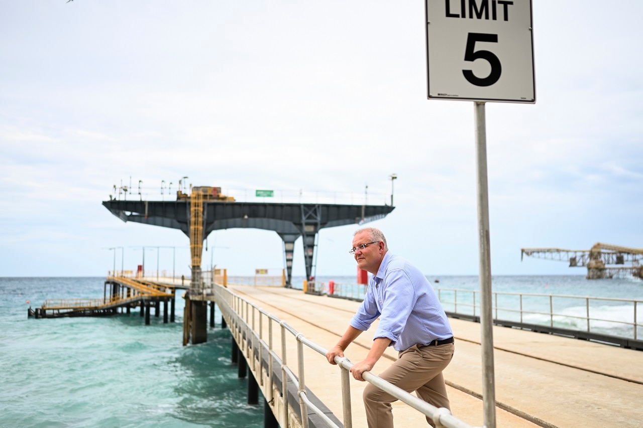 Prime Minister Scott Morrison poses for photographs on Christmas Island after announcing it's reopening.