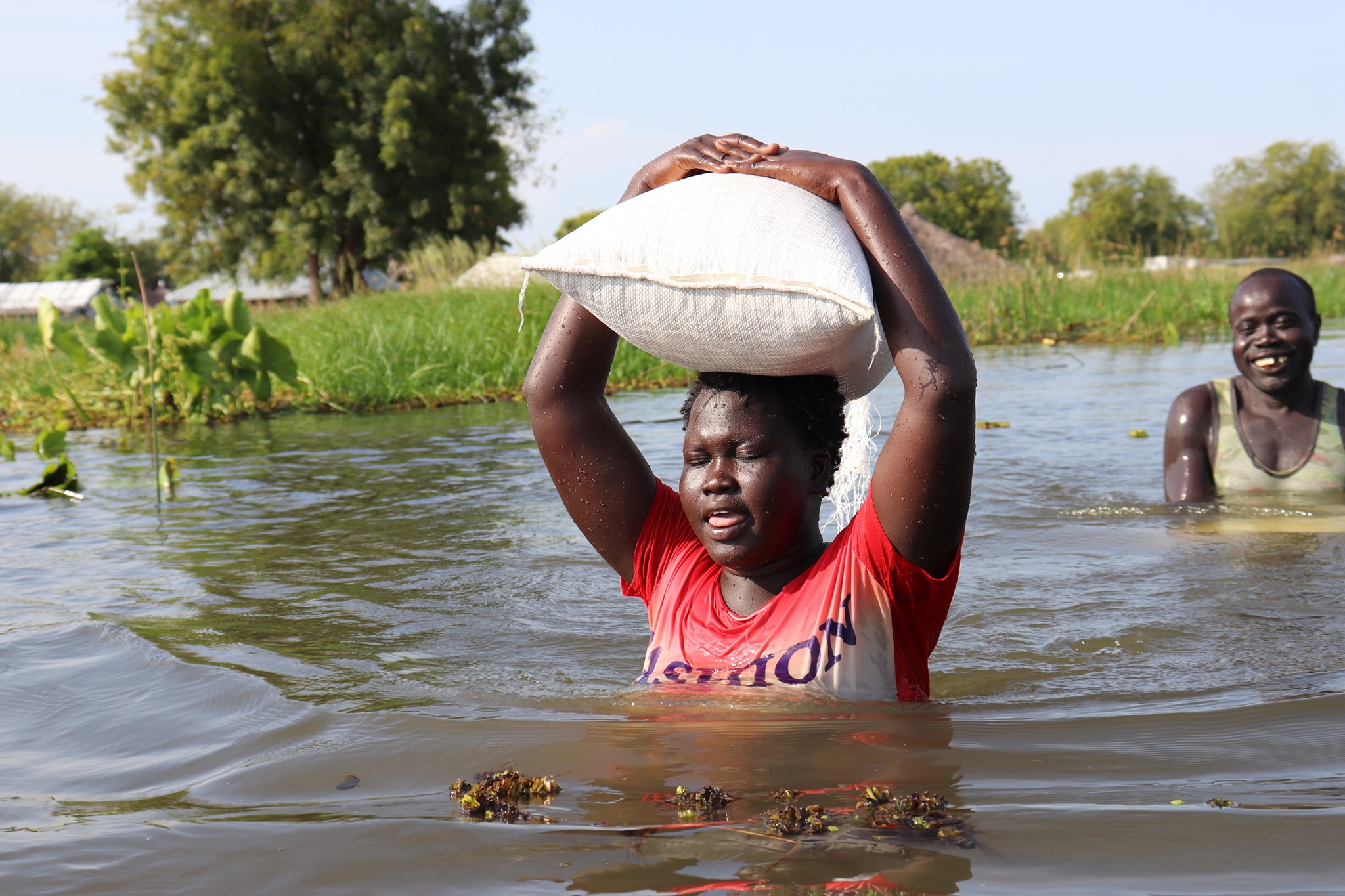 A woman helps build a dyke in Jonglei state.