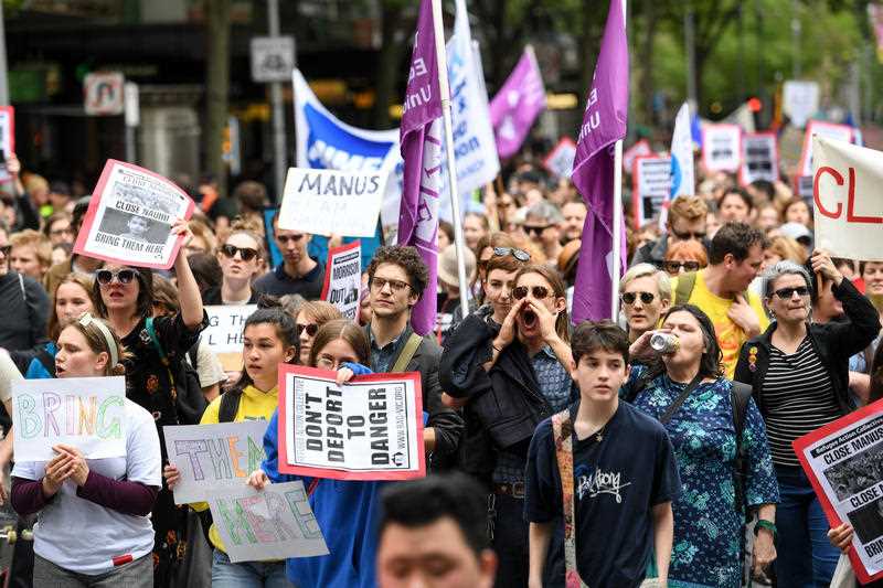 Demonstrators in Melbourne rally, calling for politicians to bring refugees from Nauru and Manus Island to Australia.