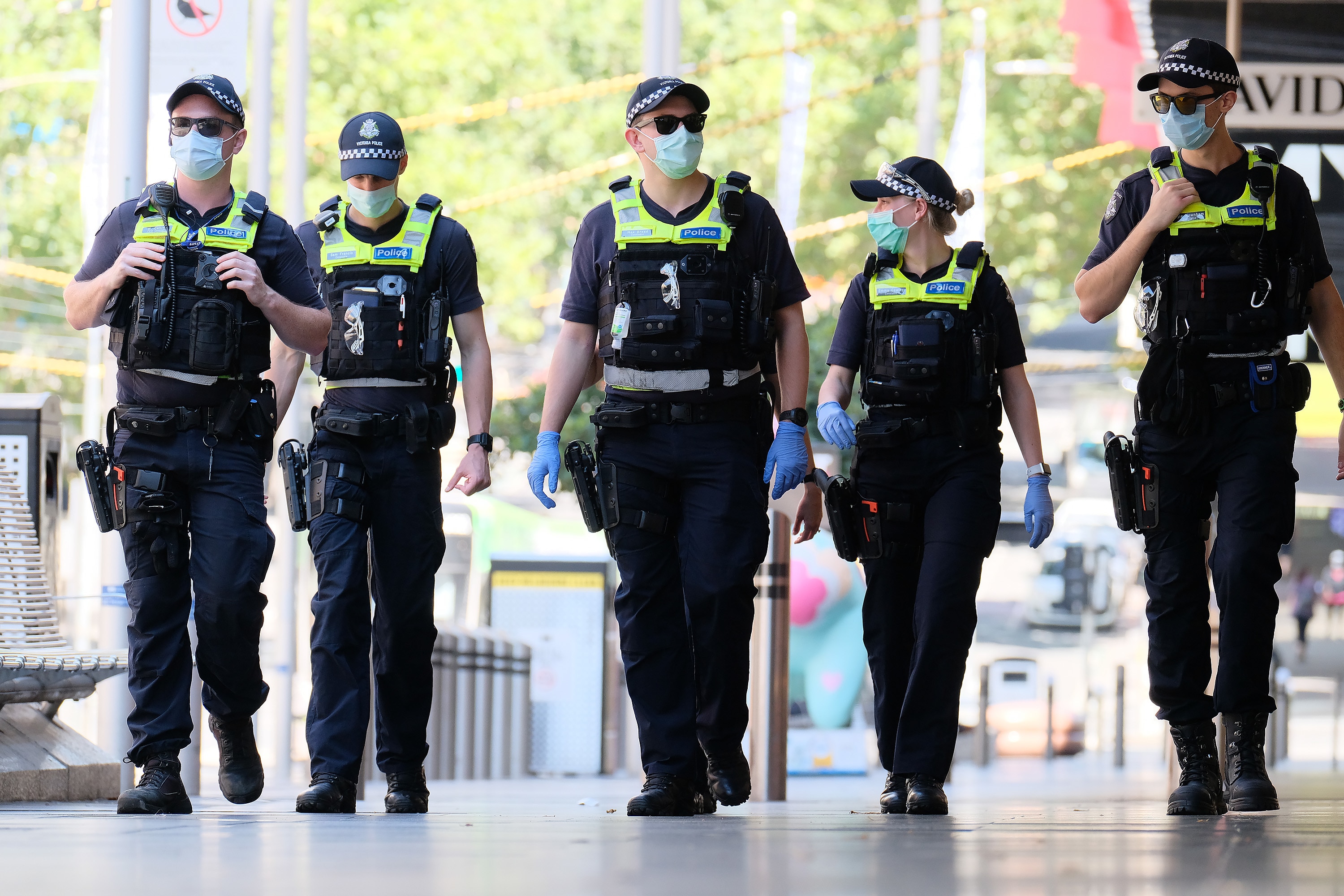 Victorian Police officers walk around  Melbourne’s CBD , Monday, February 15, 2021. Victorians are in lockdown for the third time amid fears the highly infectious UK strain of coronavirus has spread in the community. (AAP Image/Luis Ascui) NO ARCHIVING