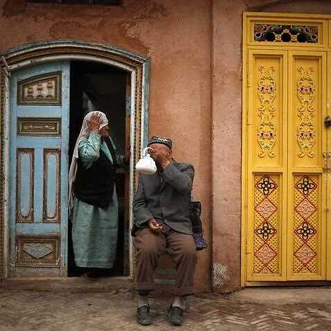  A man of the Uighur ethnic group has tea while his wife looks on in the old town of Kashgar, Xinjiang Uighur Autonomous Region, China, 24 May 2013. 