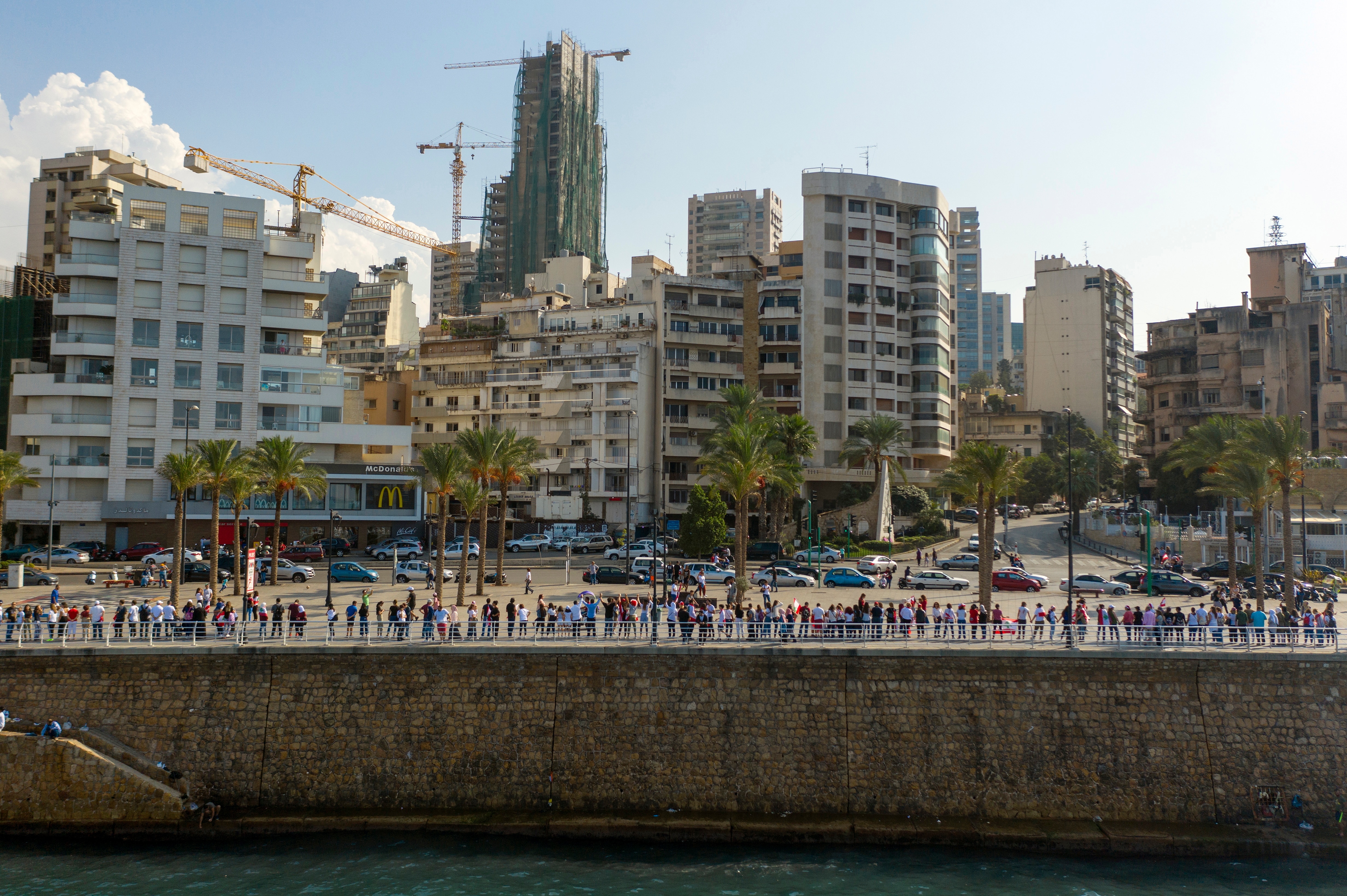 A picture taken with a drone shows an aerial view of Lebanese protesters forming a human chain.