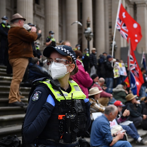 People are seen during a demonstration outside the Victorian State Parliament in Melbourne, Tuesday, 16 November, 2021. 