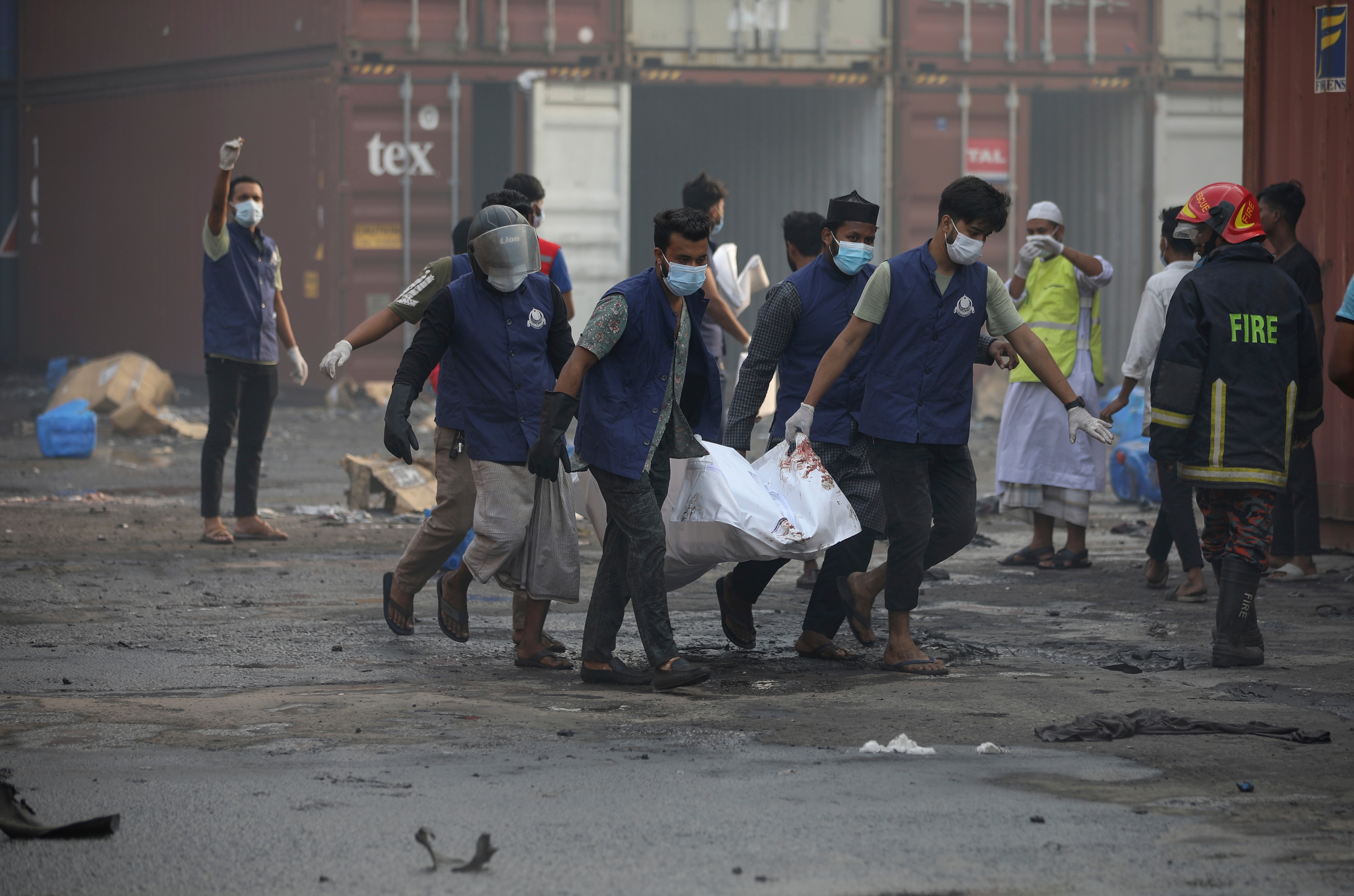 The body of one of the victims is carried after a fire broke out at the BM Inland Container Depot in Chittagong, 216 km southeast of capital, Dhaka, Bangladesh.