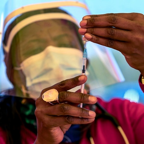 A health worker prepares a dose of vaccine at a mass vaccination centre in South Africa