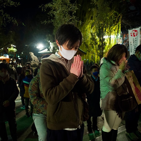 People pray at Asakusa Shrine on New Year's Day in Tokyo early Friday, Jan. 1, 2021. (AP Photo/Hiro Komae)