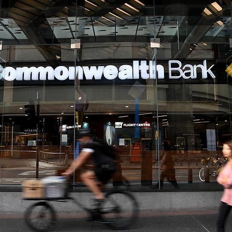 People walk by a Commonwealth Bank