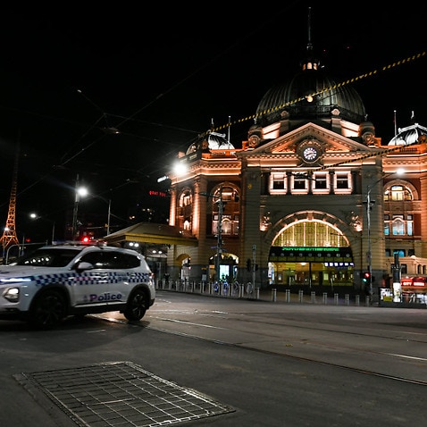 A police car is seen outside Flinders Street Station after a citywide curfew is introduced in Melbourne, Sunday, 2 August, 2020. 