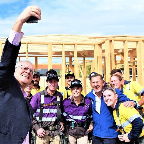 (L-R) Prime Minister Scott Morrison takes a selfie with Liberal member for Braddon Gavin Pearce and apprentices on a building site in Spreyton, Tasmania, Sunday, April 3, 2022. (AAP Image/Sarah Rhodes) NO ARCHIVING