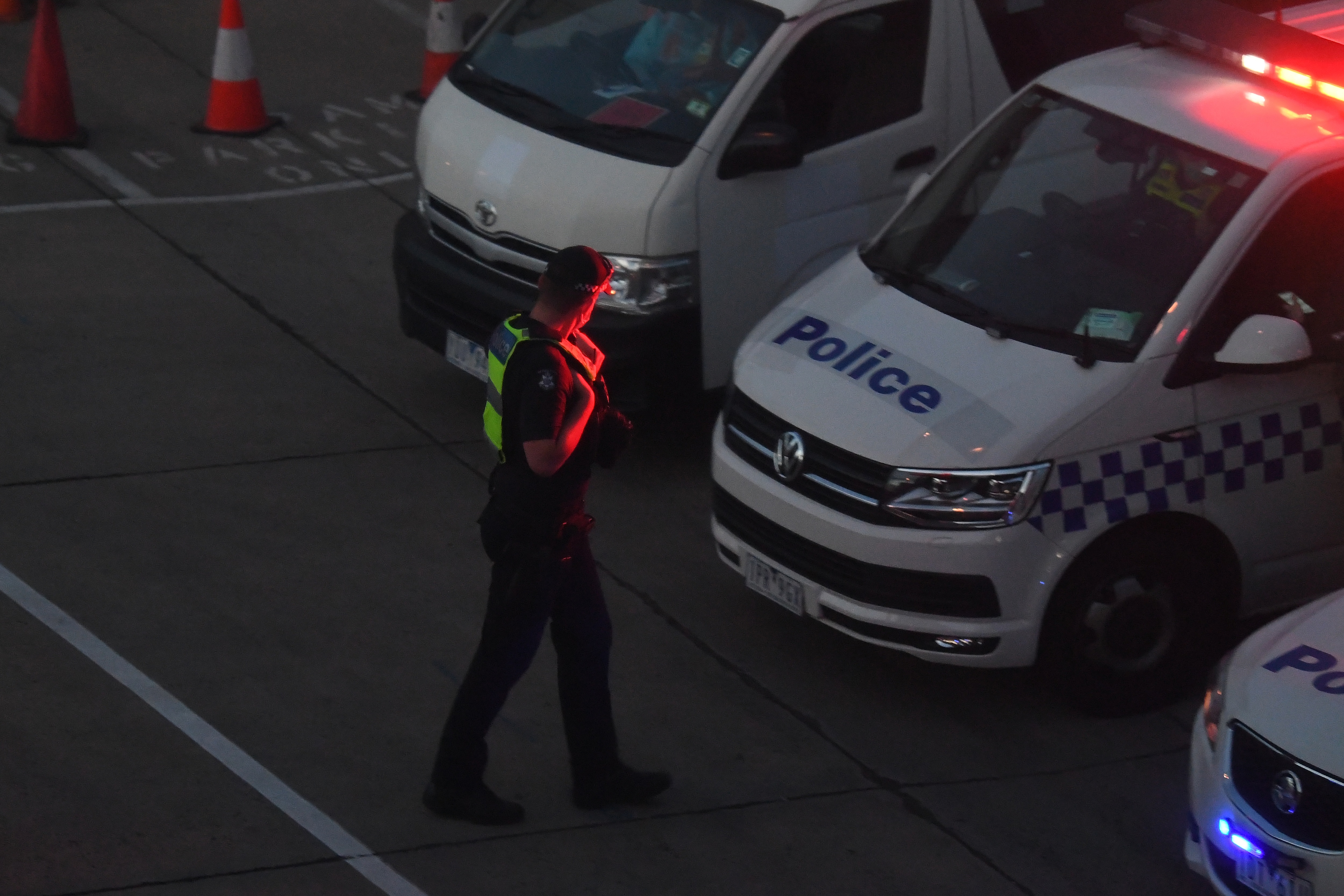 Victorian Police are seen at Melbourne International Airport as Malka Leifer is reported to have arrived on Wednesday, 27 January.