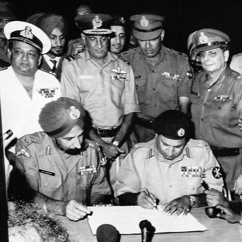 Pakistans Gen. Niazi, signs the surrender document as Joint Commander of India and Bangladesh Forces, Gen. Aurora, left, in Dacca, Bangladesh, Dec. 16, 1971.