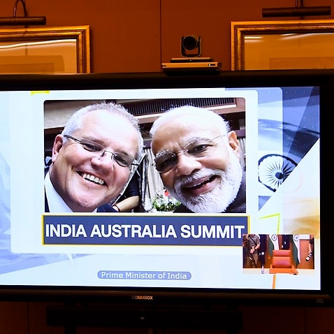 A picture of Australian Prime Minister Scott Morrison (left) and Indian Prime Minister Narendra Modi is displayed on a conference screen.