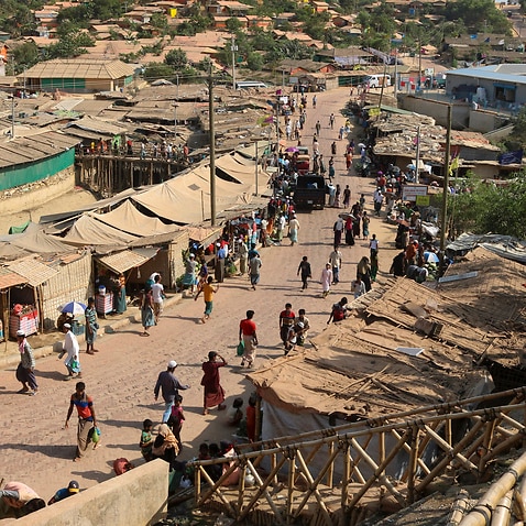 Rohingya refugees walk through one of the arterial roads at the Kutupalong refugee camp in Cox's Bazar, Bangladesh.