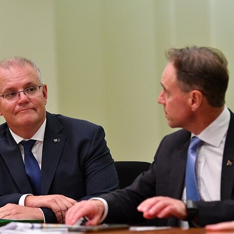 Australian Prime Minister Scott Morrison (left) and the Australian Health Minister Greg Hunt are seen during a GP roundtable conference at the Commonwealth Parliamentary offices in Melbourne, Friday, March 19, 2021. (AAP Image/James Ross) NO ARCHIVING