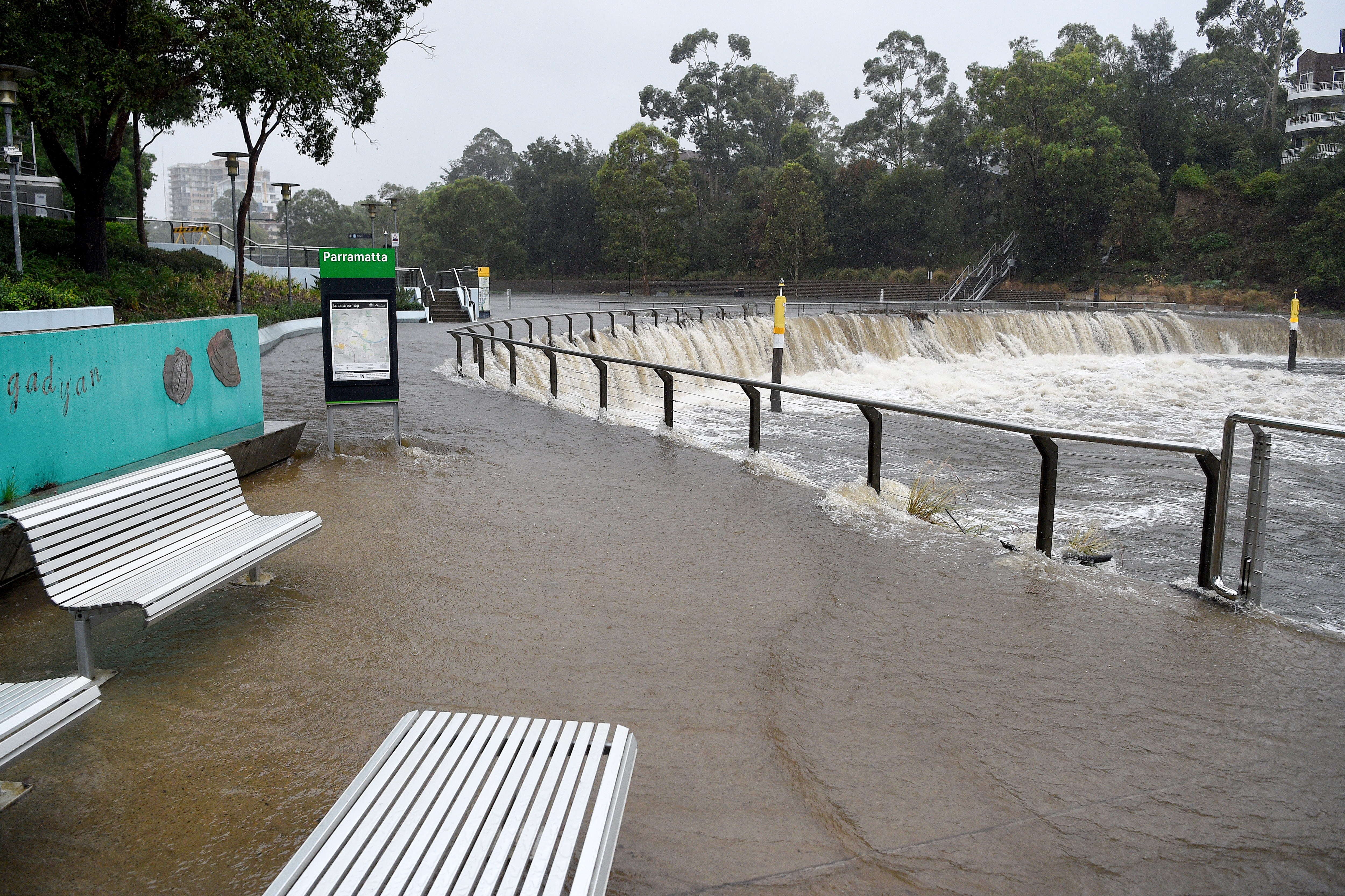 Water overflows the banks of the Parramatta River after heavy rains buffeted Sydney.